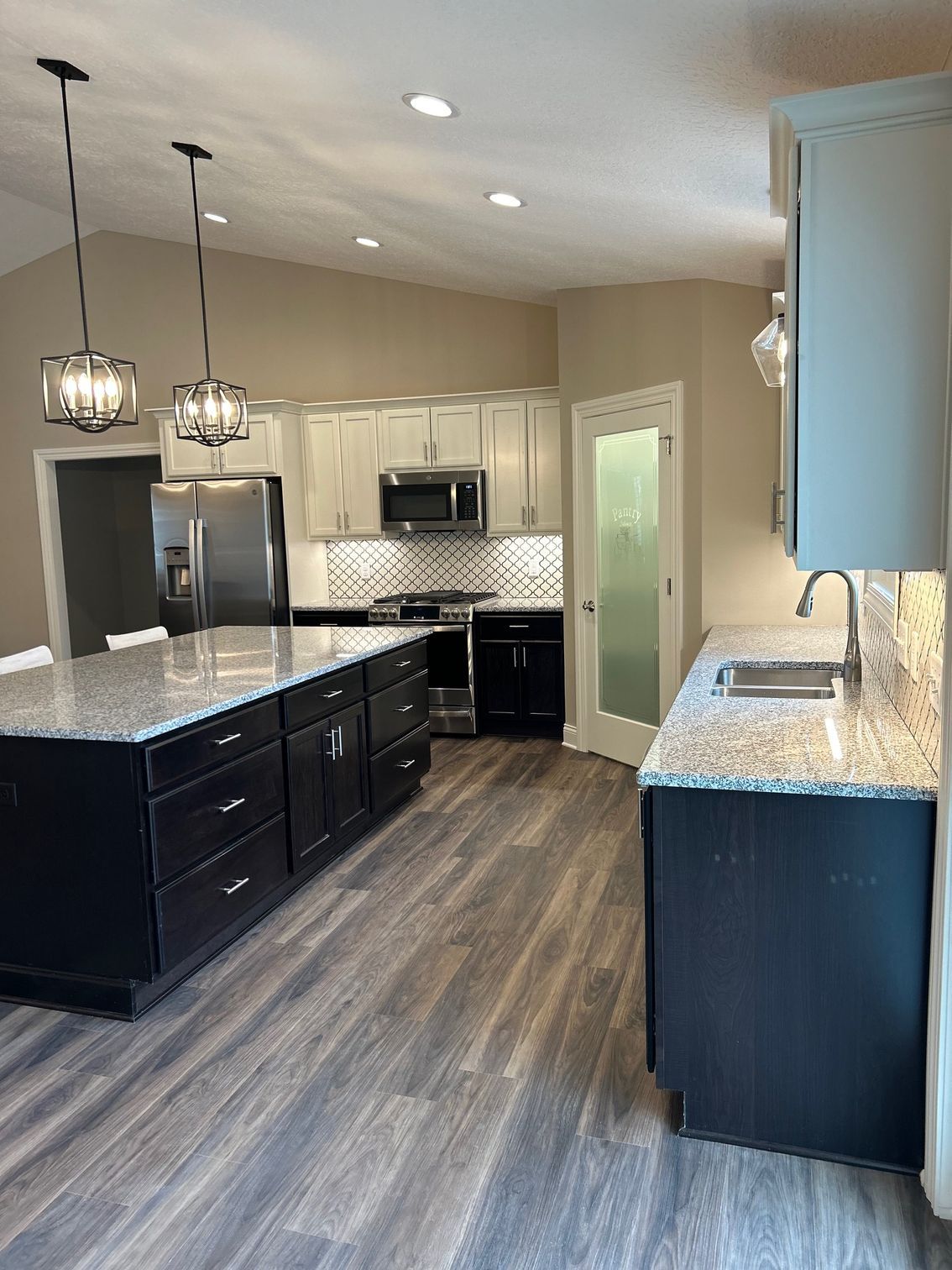 A kitchen with stainless steel appliances and granite counter tops.
