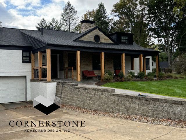 New front porch addition on a house with stone retaining wall and lawn
