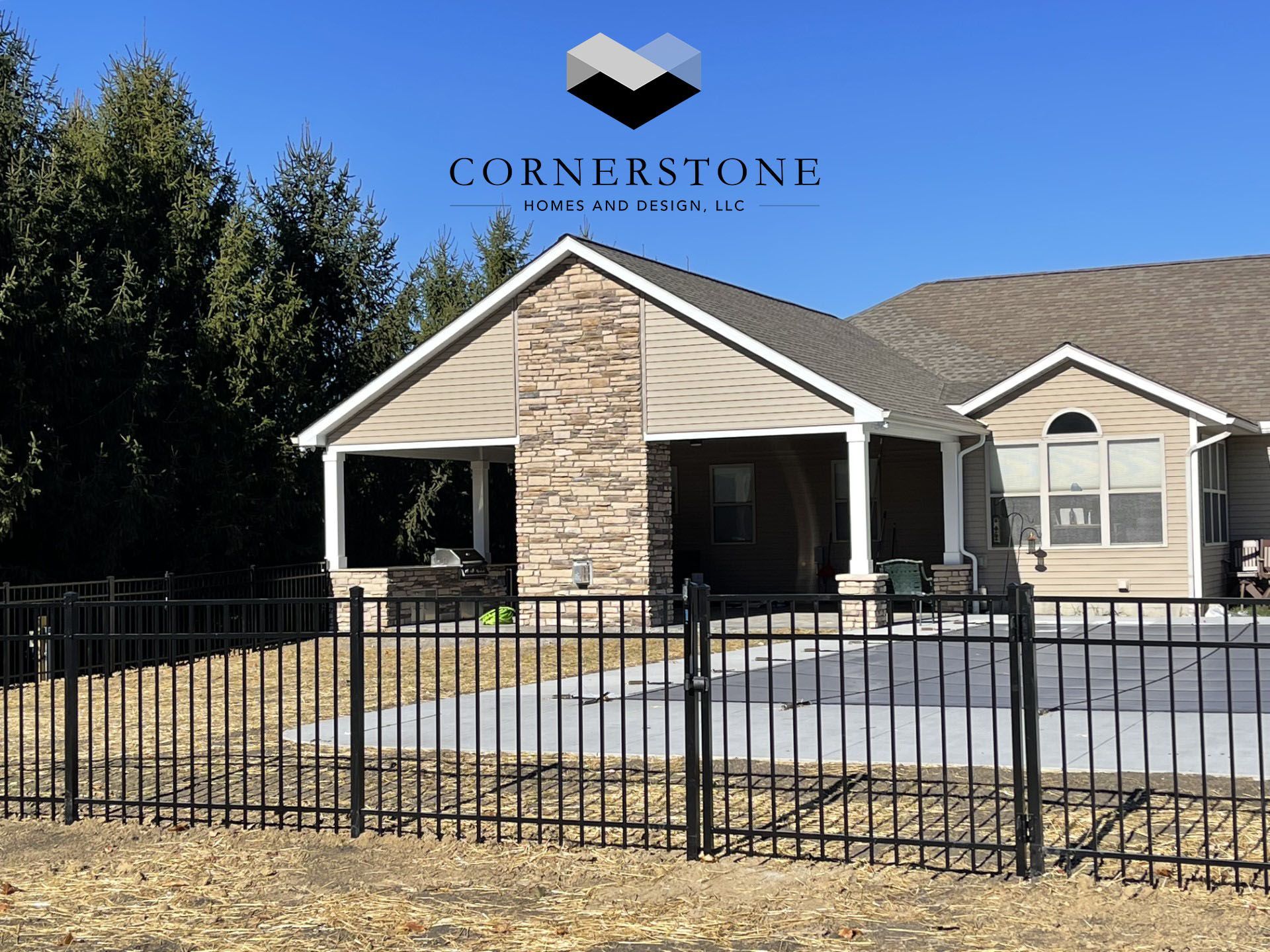 A house with a fence and a sign that says cornerstone