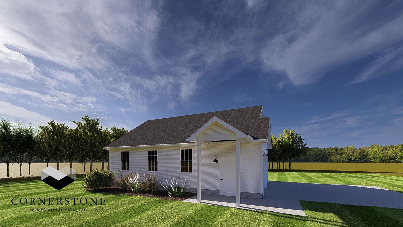 Small white house with a porch beside a grassy yard under a blue sky