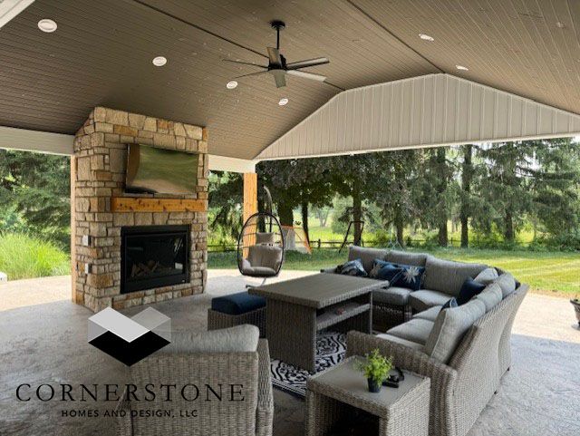 A living room with a fireplace and a ceiling fan