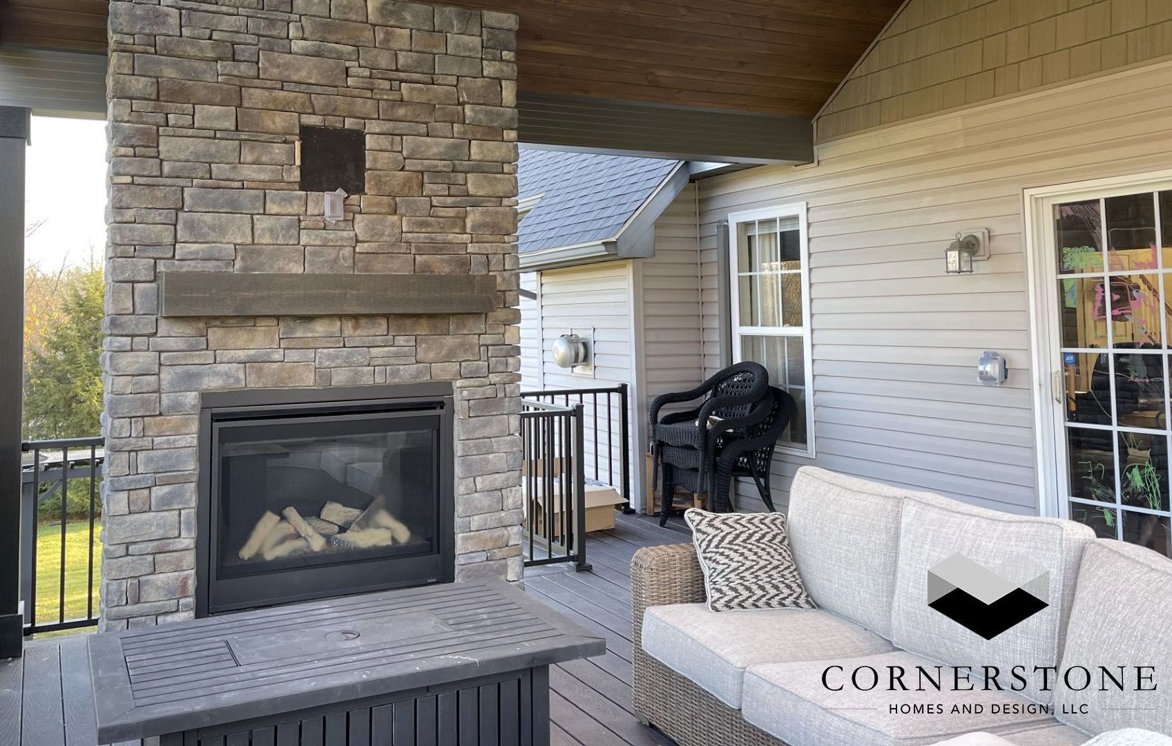 A patio with a fireplace and a couch.
