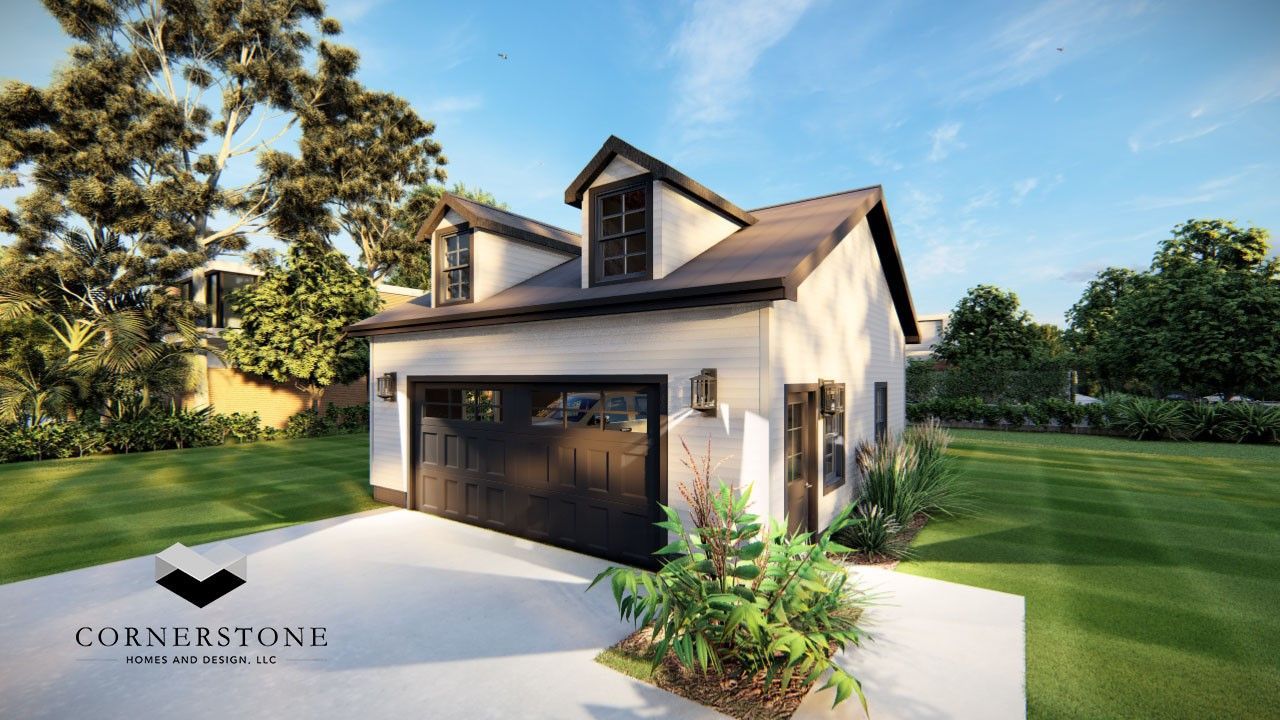 A white house with a black garage door is sitting on top of a lush green lawn.