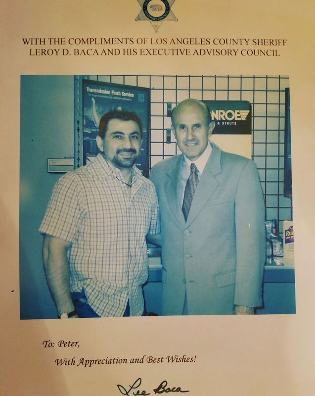 Framed photo of two men at a formal event, one in a suit, with an appreciation message above and below.