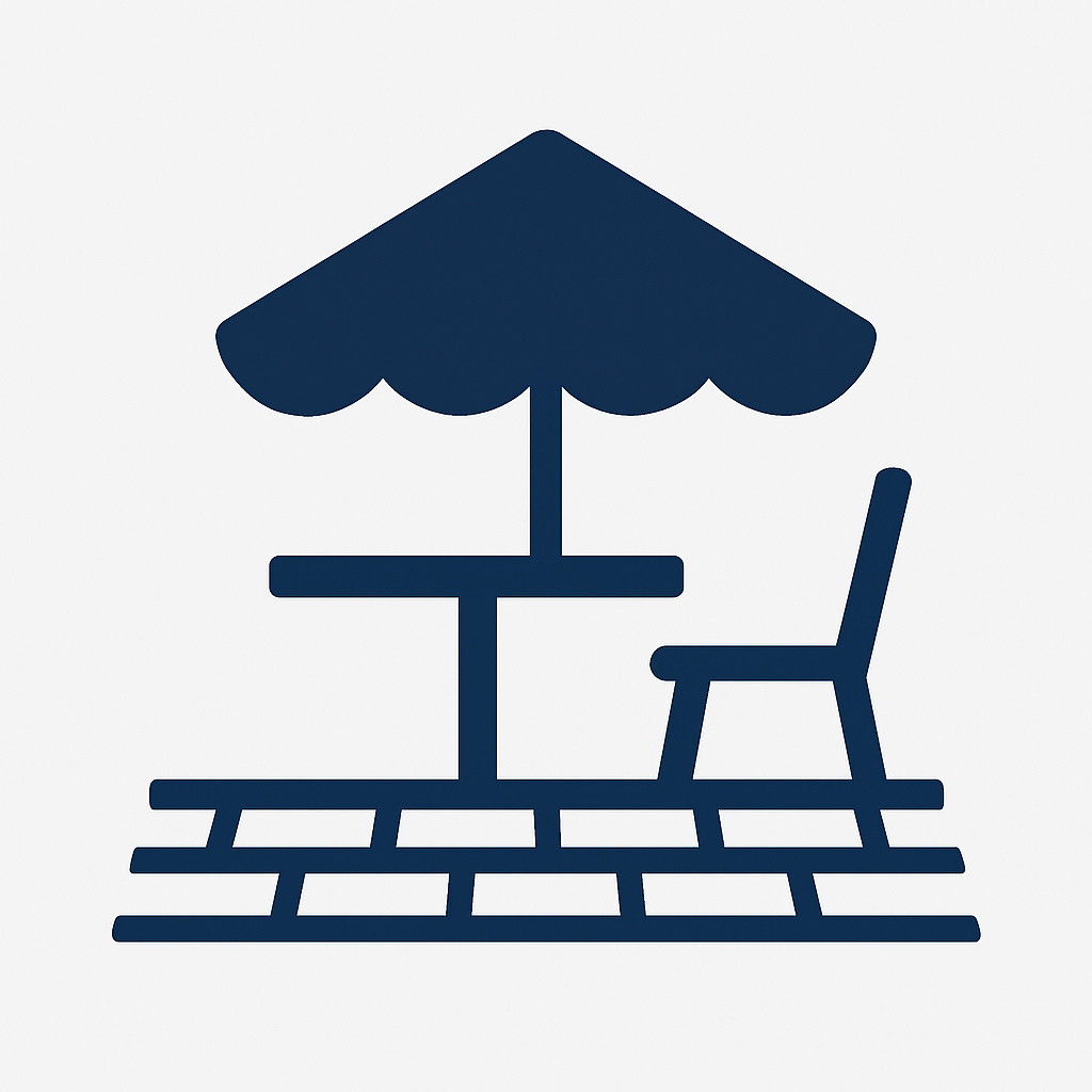 Dark blue outdoor patio with umbrella, table, and chair on a brick surface.