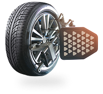 Car tire with alignment equipment attached, measuring angles.
