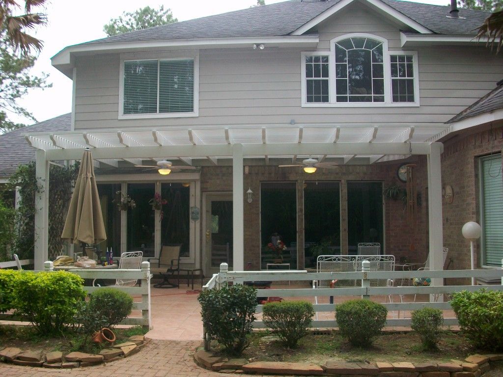 Outdoor living space in Alvin, TX with covered patio and fire pit