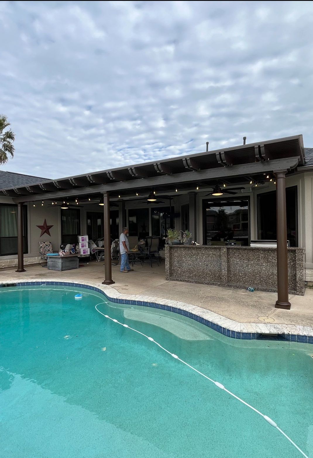 Custom patio cover build in Houston TX with aluminum roof and recessed lighting