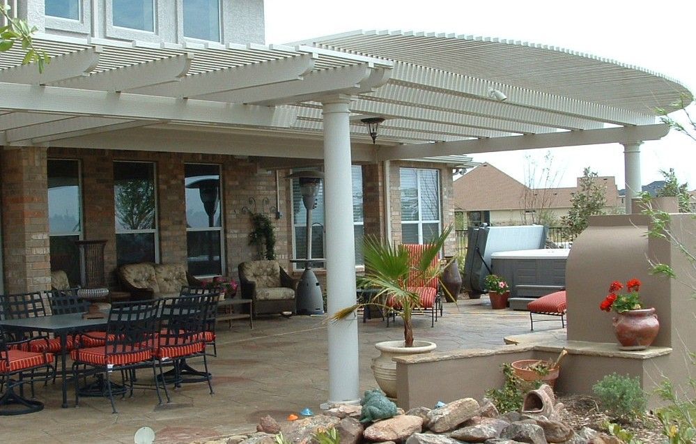 Comparison of a modern white aluminum pergola and traditional cedar pergola styles for a Houston bac