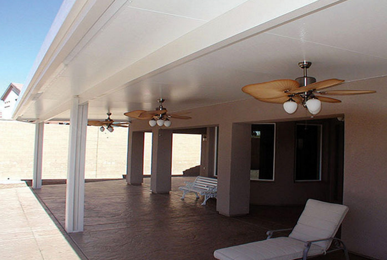 Custom patio cover in Katy TX with fan and lighting