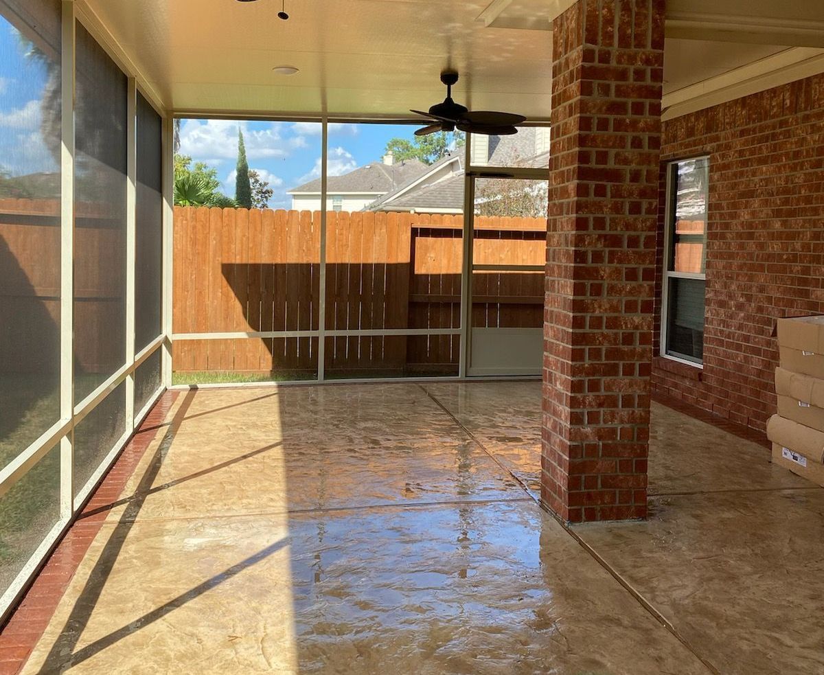 Decorative stamped concrete screen room in Houston backyard