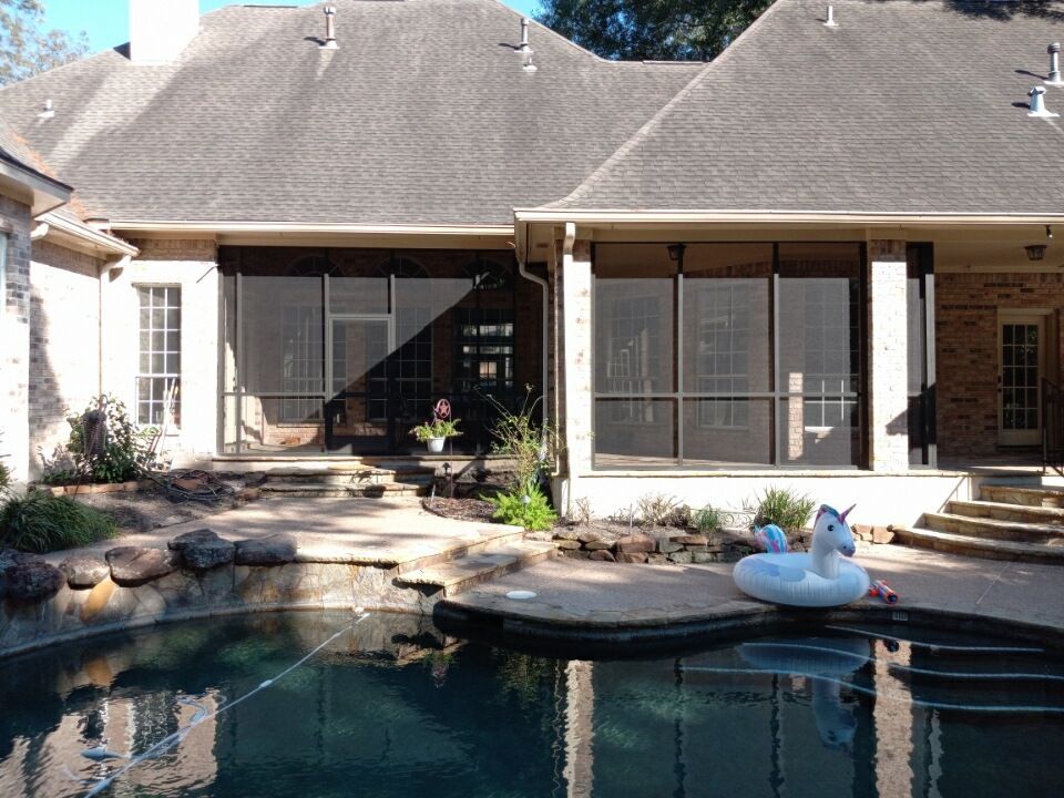 Cedar-framed screen room in Friendswood, TX featuring screened doors and natural wood accents.