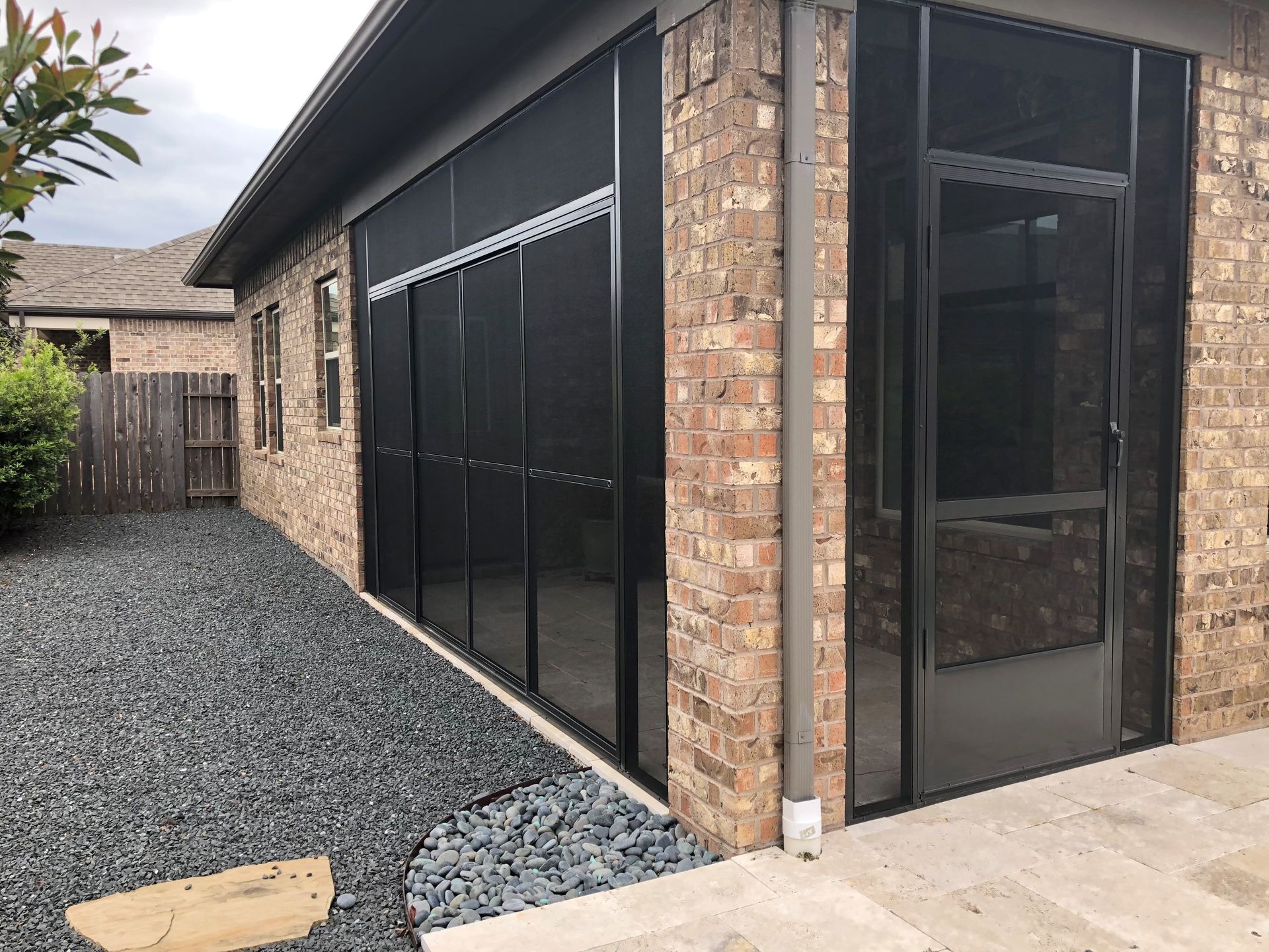 Backyard screen room in Spring, TX with skylights and cedar accents for natural lighting and ventilation.