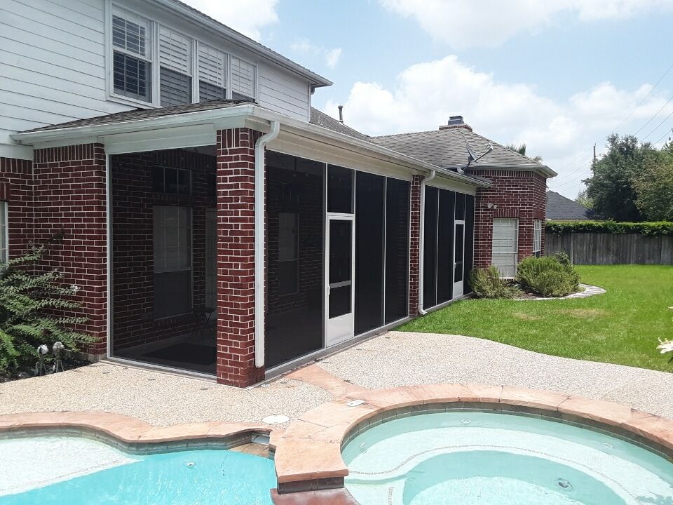 Enclosed Houston patio with ceiling fan and UV-resistant screened walls.