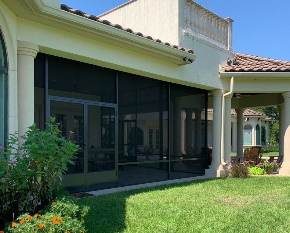 Patio enclosure in Houston with French doors and ceiling fan