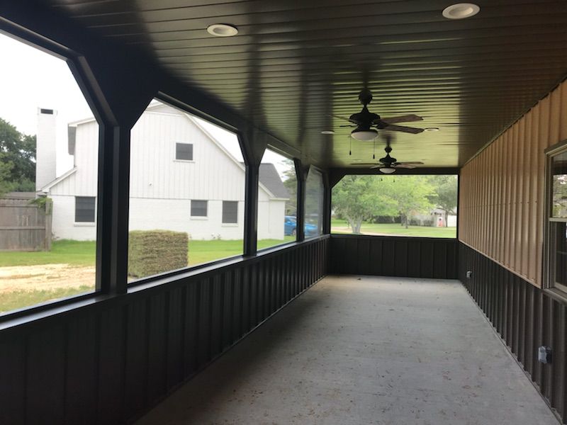 Backyard patio enclosure with aluminum frame and mesh panels