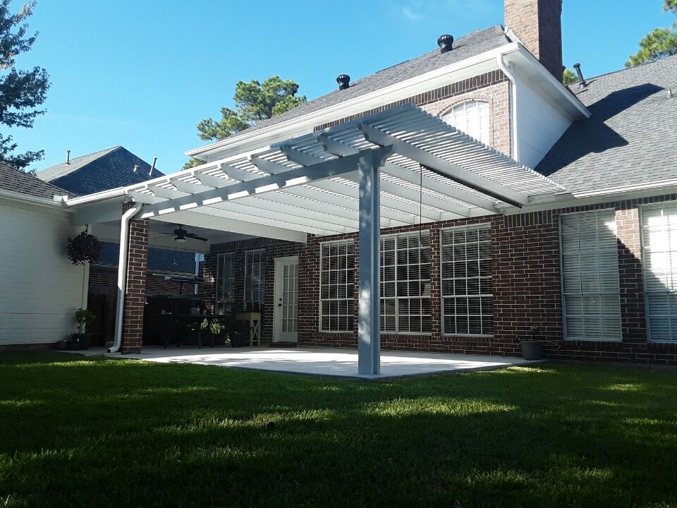A brick house with an Alumawood pergola in Richmond, TX.