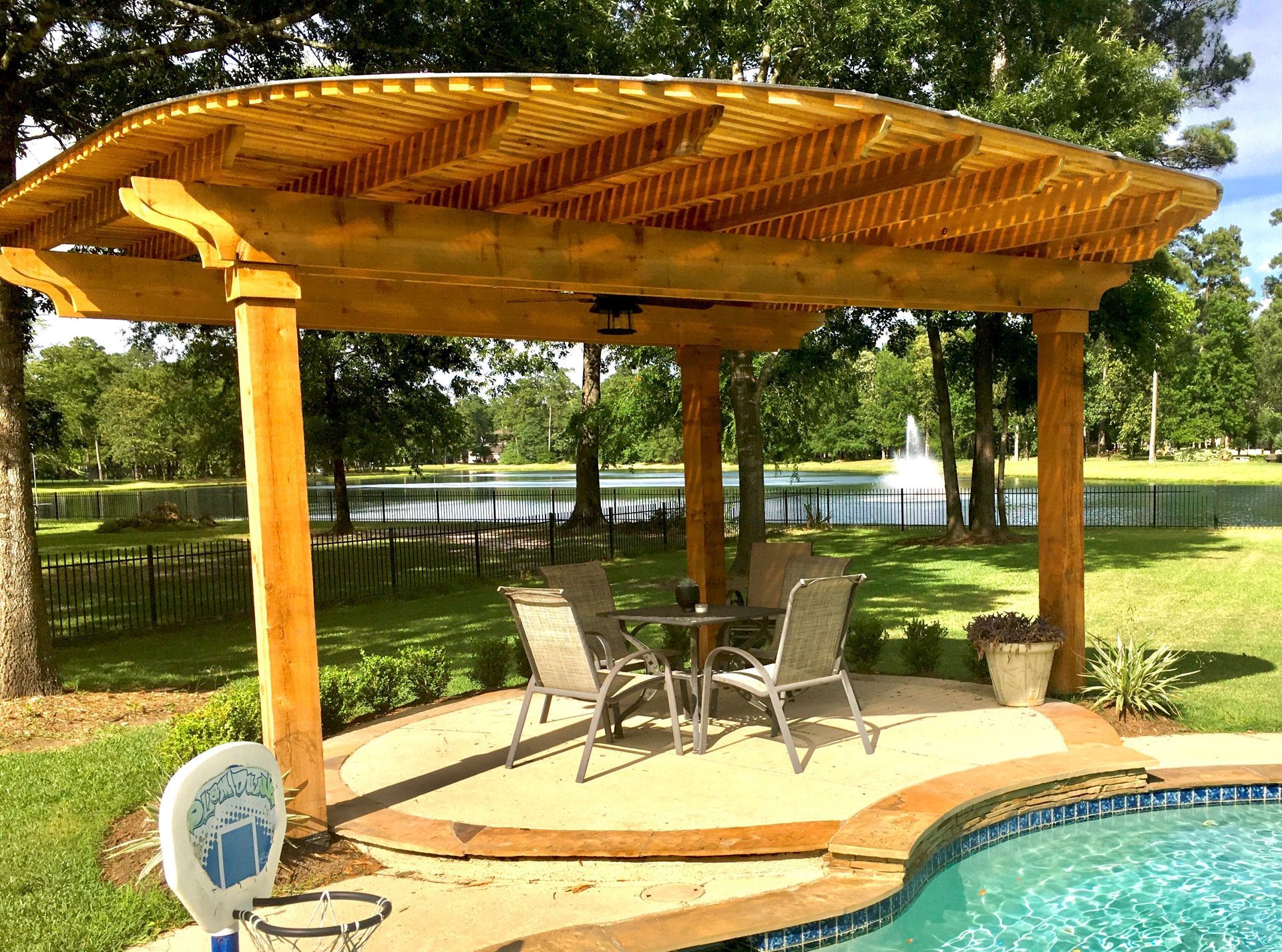 Freestanding poolside shade pergola engineered to TDI windstorm standards for a Houston home.