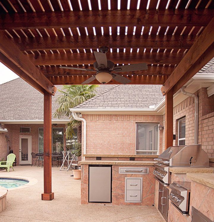 Custom cedar wood pergola installation with hurricane-rated engineering in Sugar Land, TX.