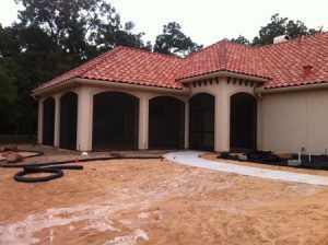 Wrap-around patio enclosure in Deer Park, TX with dual access and screened walls for extended backyard coverage.