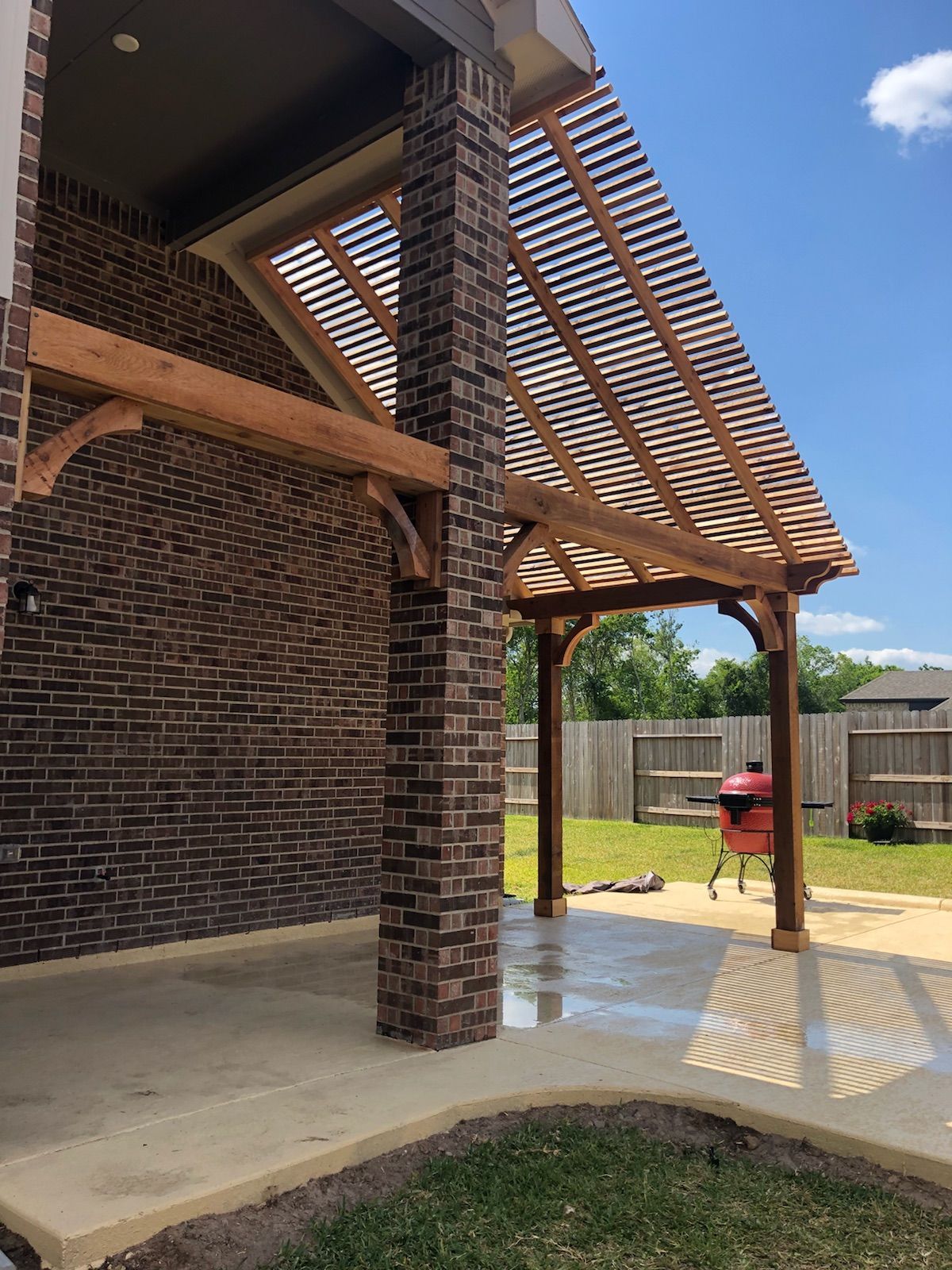 Outdoor cedar pergola with seating in Conroe