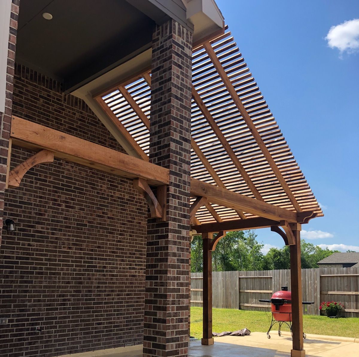Custom attached patio pergola design with hurricane-rated engineering in Houston, Texas.