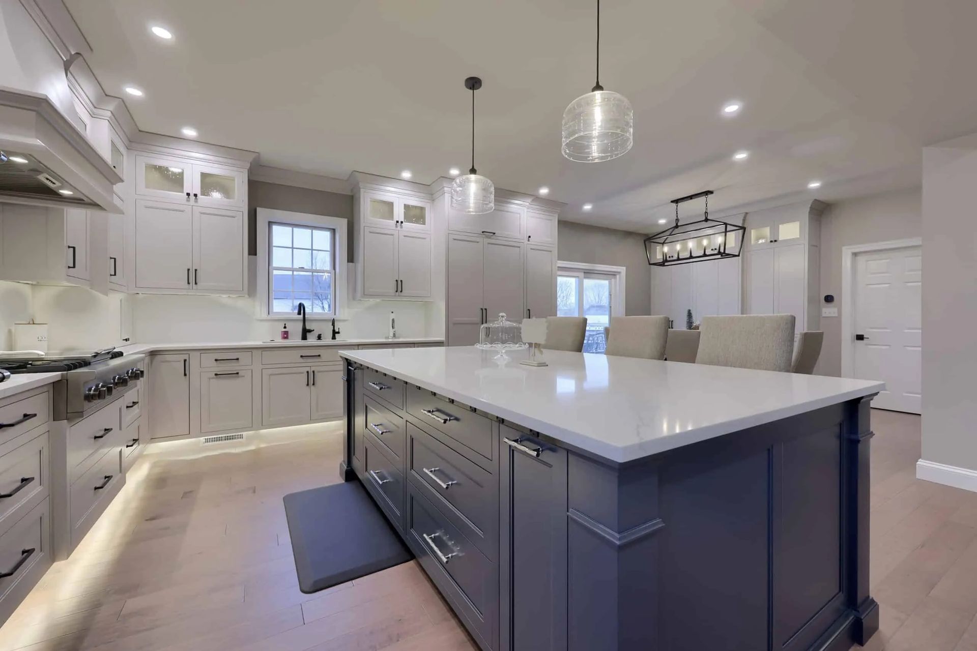 Bright modern kitchen with white cabinets, a large island, and stainless steel appliances