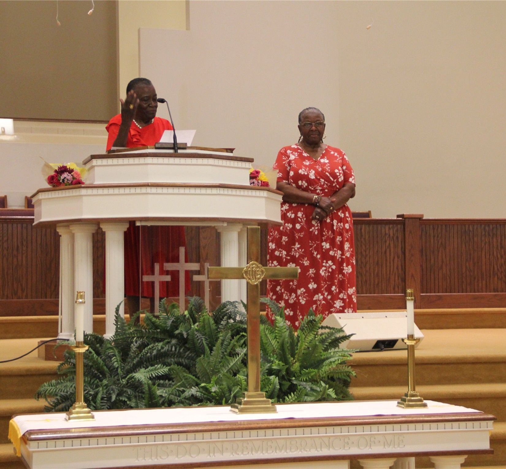 A large group of people are standing in a church.