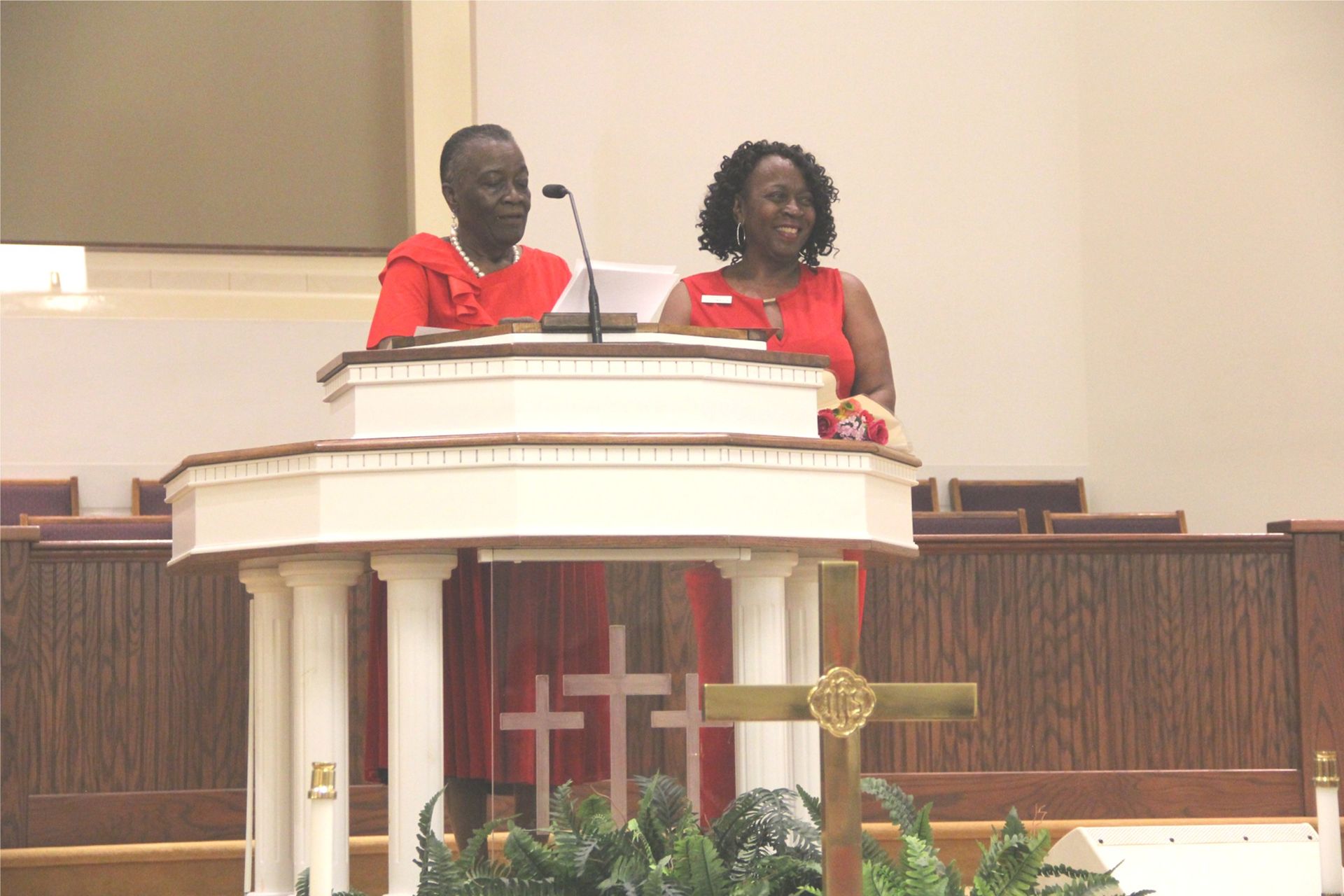 A group of people in black suits are standing in a church.