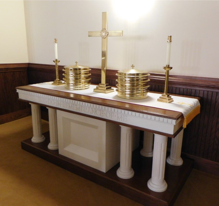 An altar with a cross and candles on it