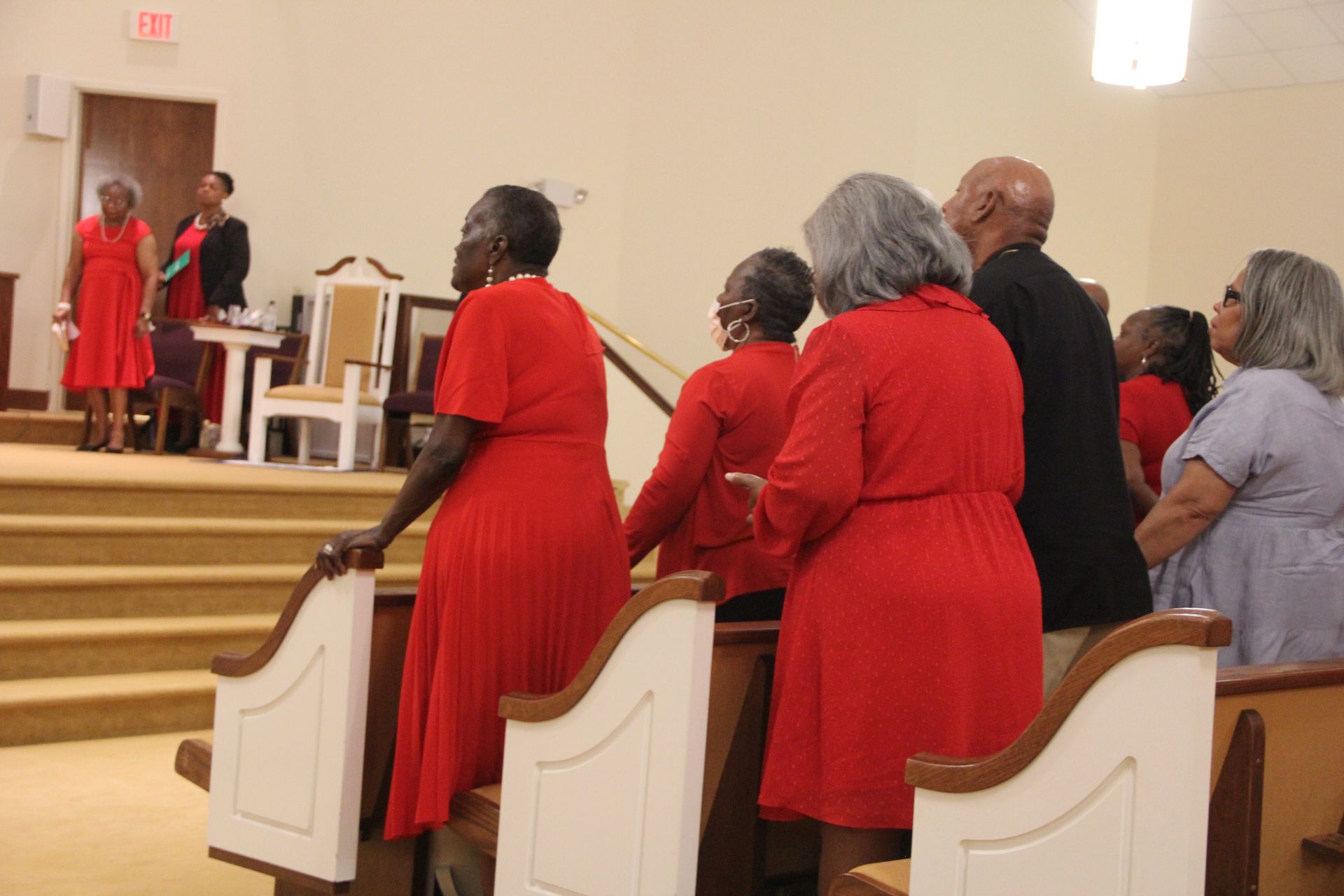 A man is being baptised by another man in a bathtub
