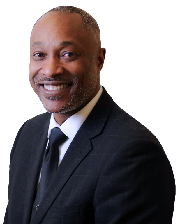 Pastor Paul D. Flowers Sr. in a suit and tie is smiling for the camera