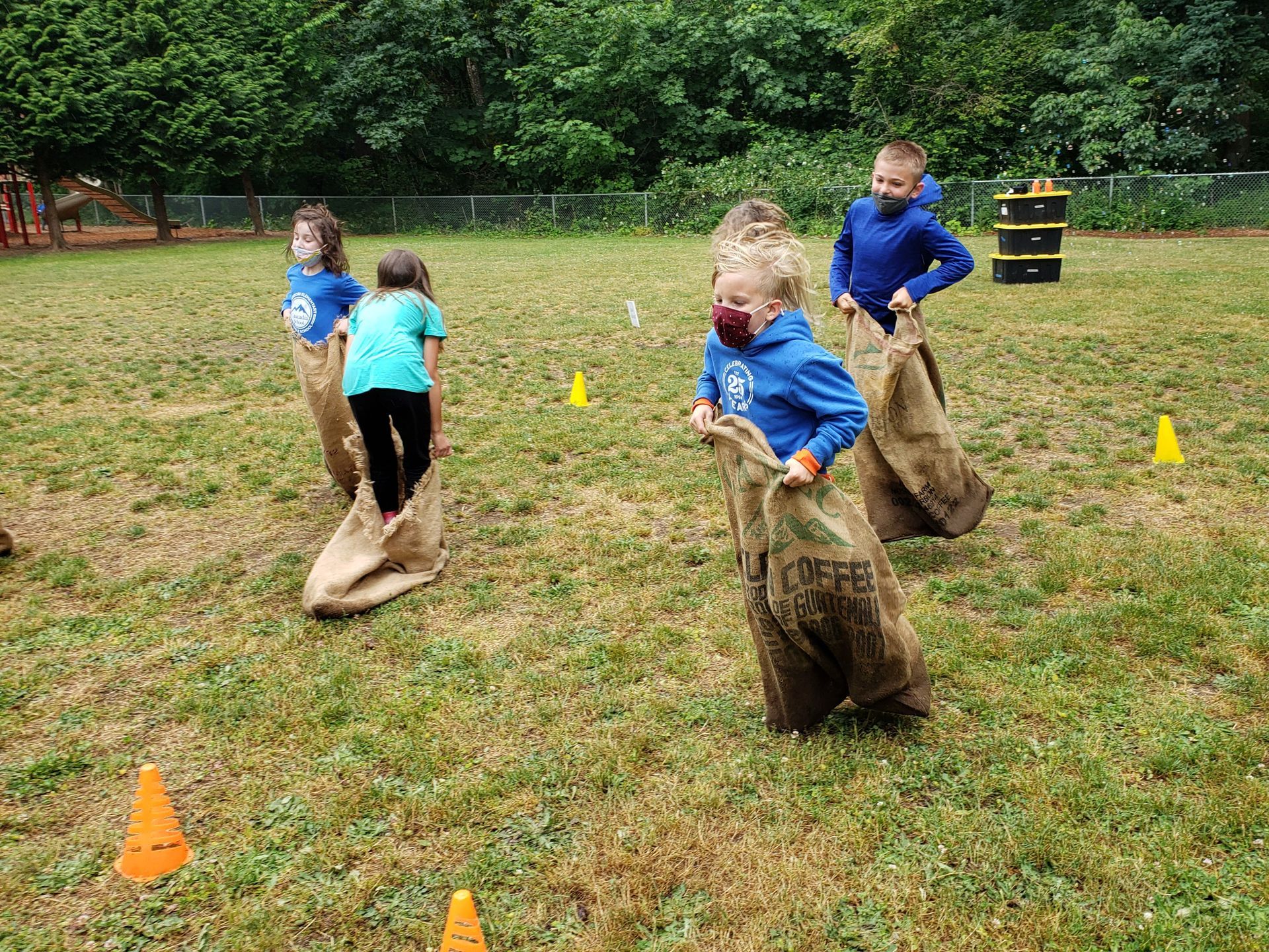 A group of children are playing a game in a field.