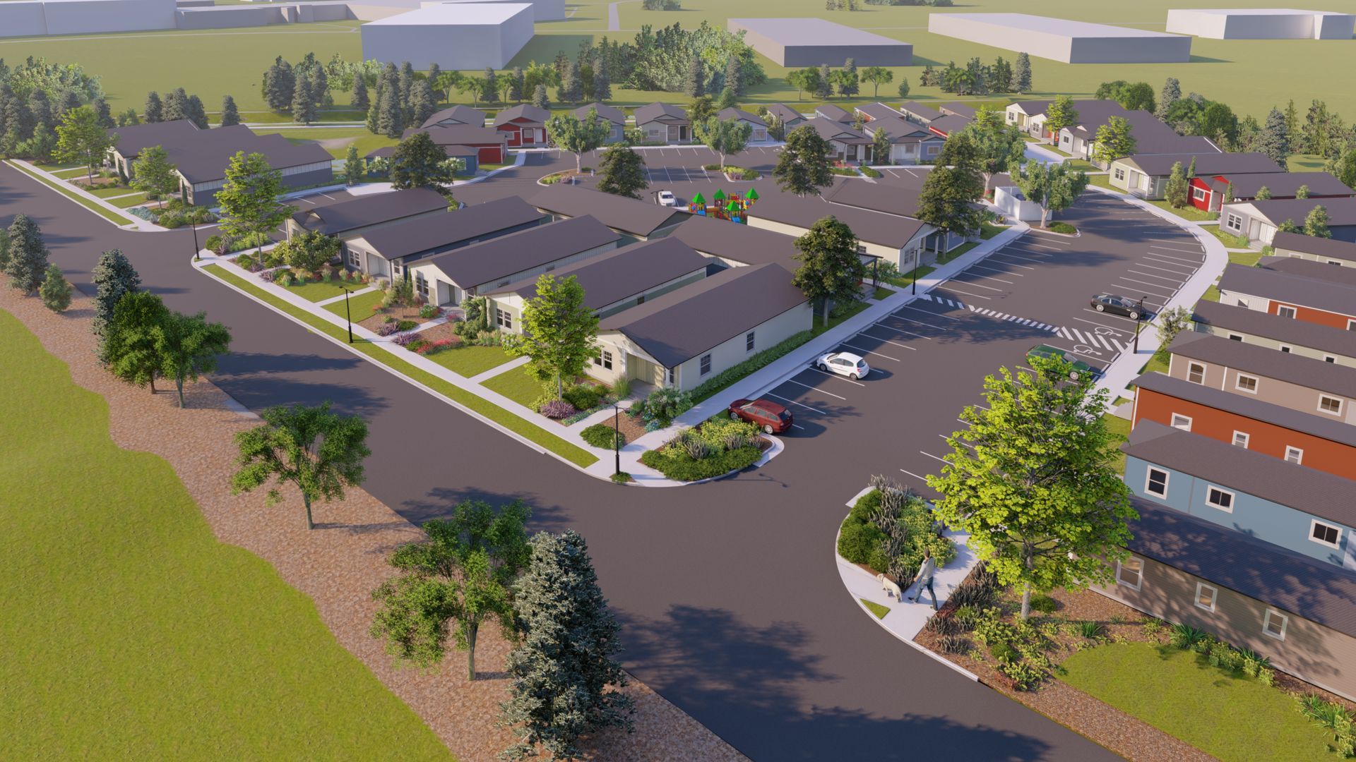 Aerial view of a suburban apartment complex with parking lot, trees, and surrounding roads