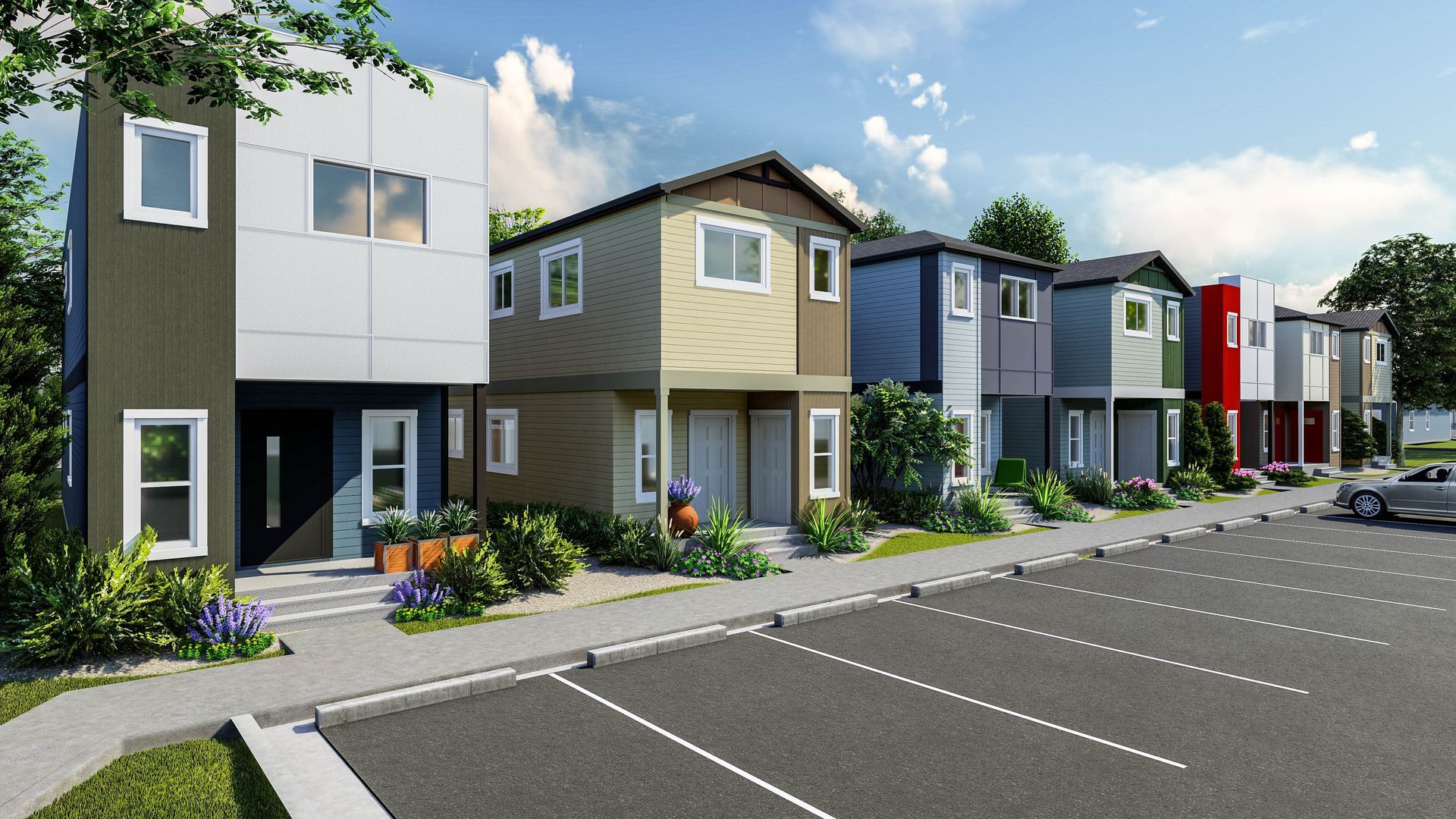 Row of modern townhouses beside an empty parking lot on a sunny day
