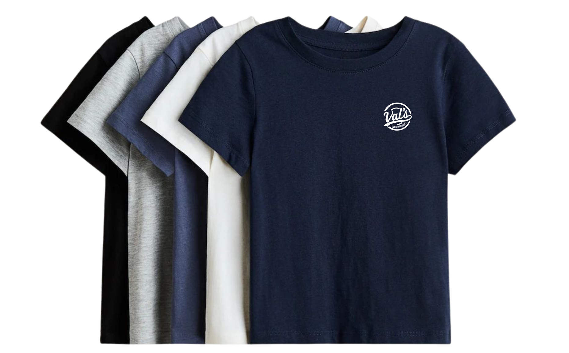 Stack of folded T-shirts in black, white, gray, light blue, and navy blue, with navy shirt in front