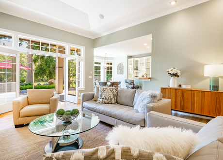A living room filled with furniture and a glass coffee table.