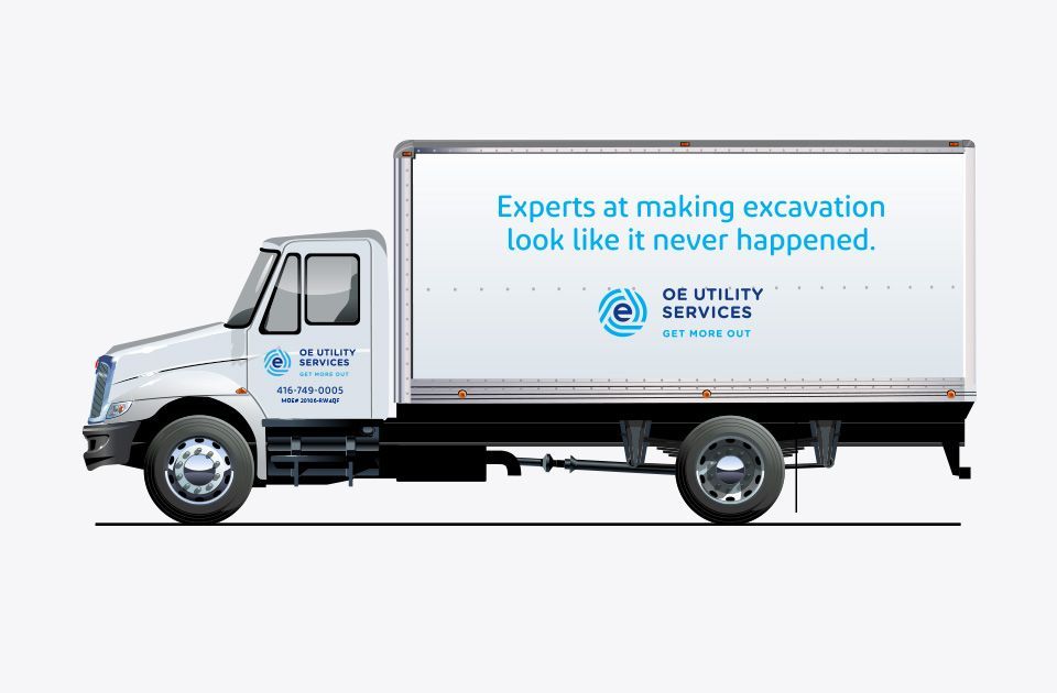 Side of white van with OE Utility Services logos