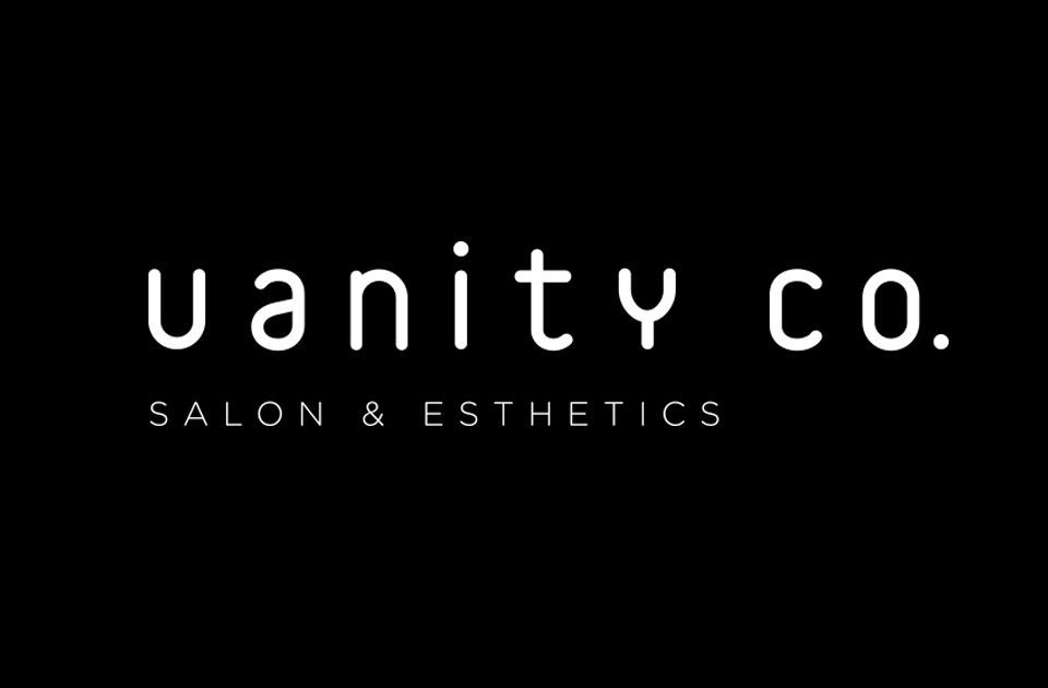 A black and white logo for Vanity Co. salon and esthetics company.