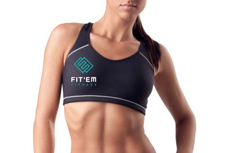 Female personal trainer with FIT’EM Fitness logo on athletic top