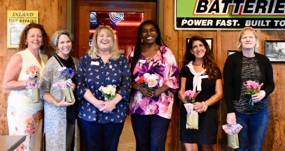 A group of women are standing next to each other for a charity event.