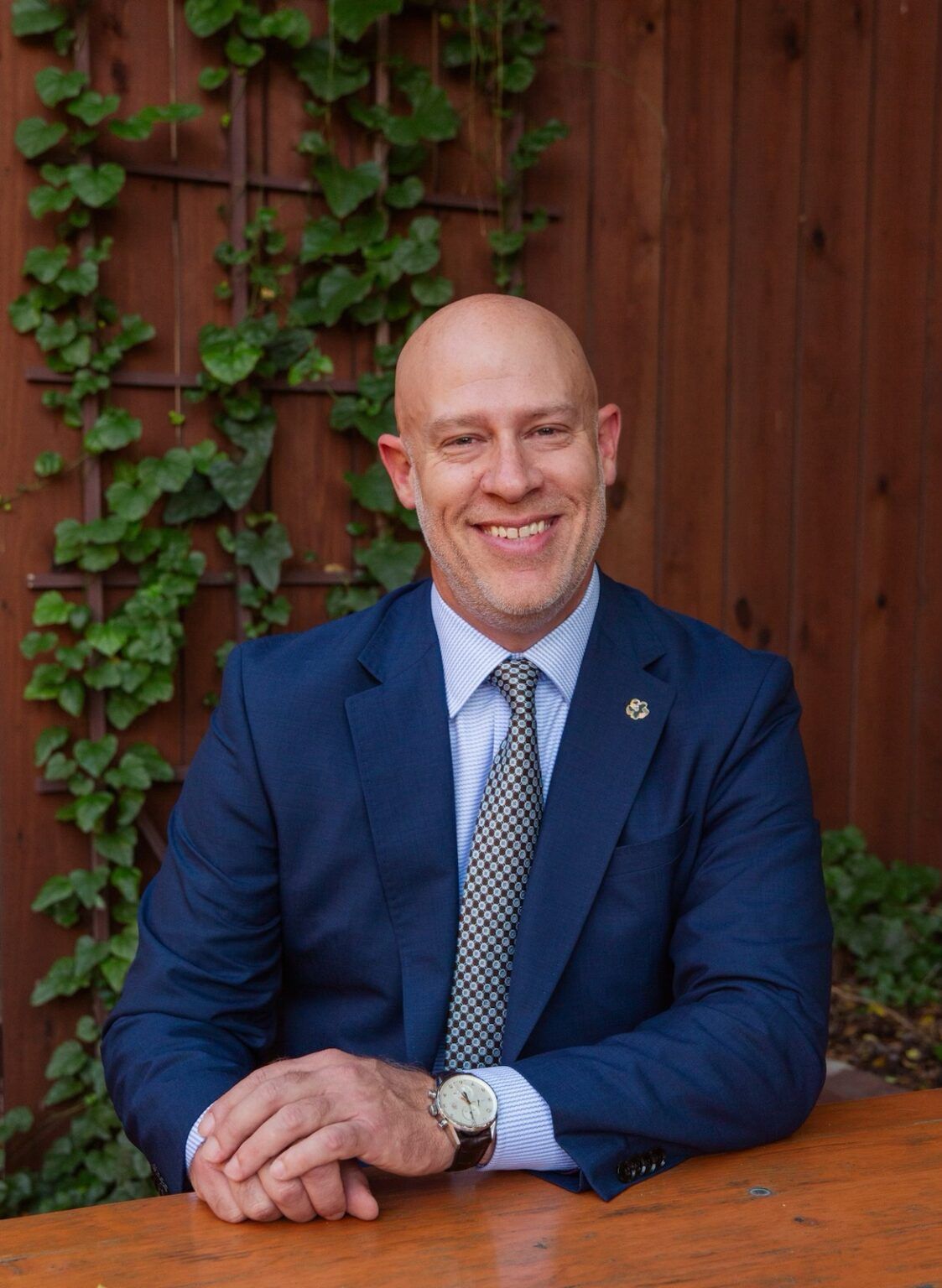 A man in a suit and tie is sitting at a table.