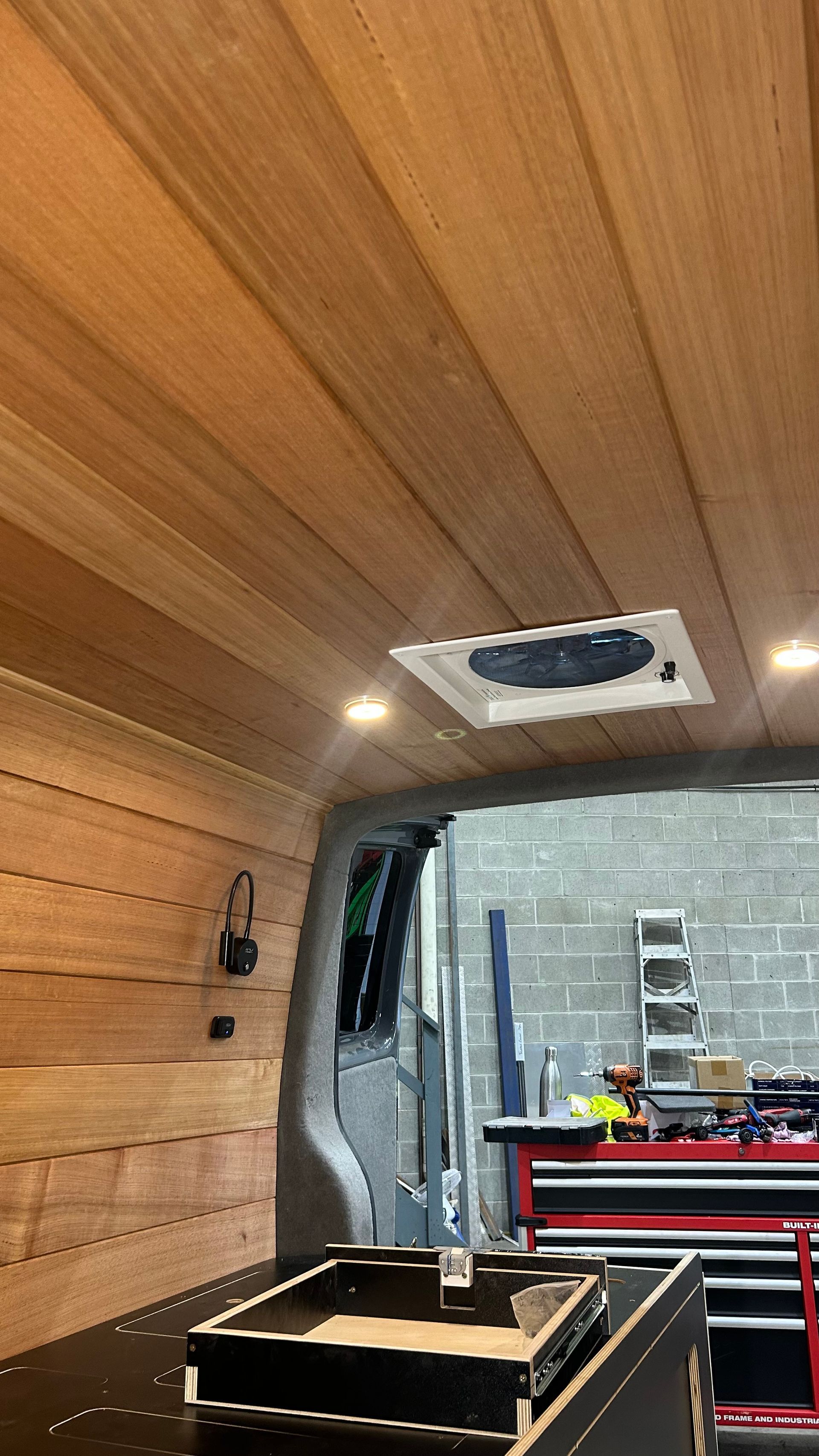 The inside of a van with timber walls— Scotts Auto Air & Electrical In Wollongong, NSW