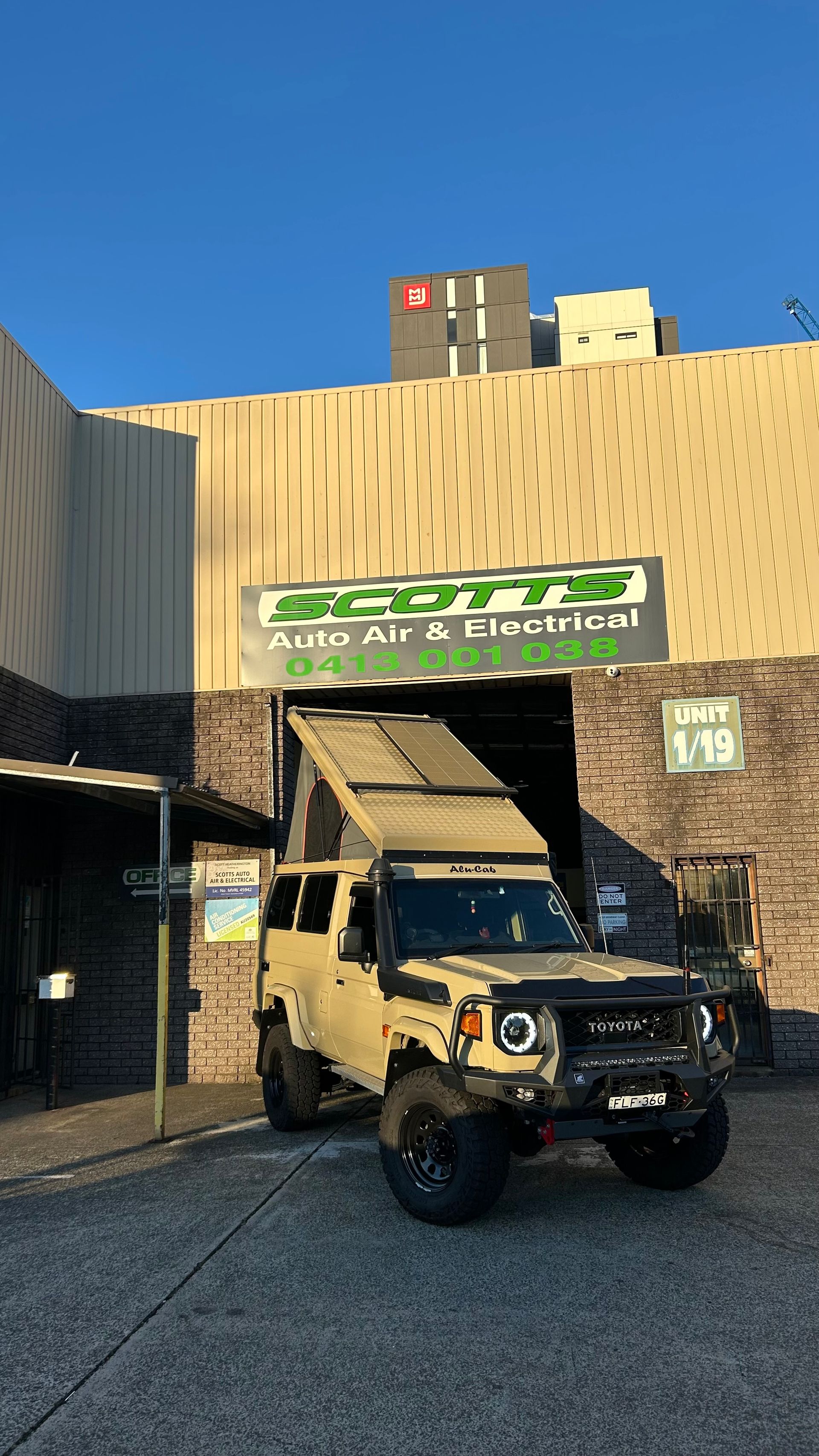 A car parked in front of a mechanic shop — Scotts Auto Air & Electrical In Wollongong, NSW