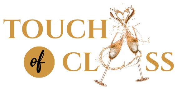 A logo for touch of class with two glasses of champagne