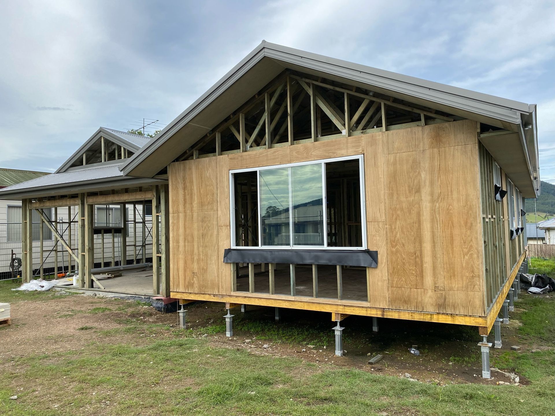 House Under Construction With Exposed Wooden Frame — BK Building Services Pty Ltd In Taree, NSW
