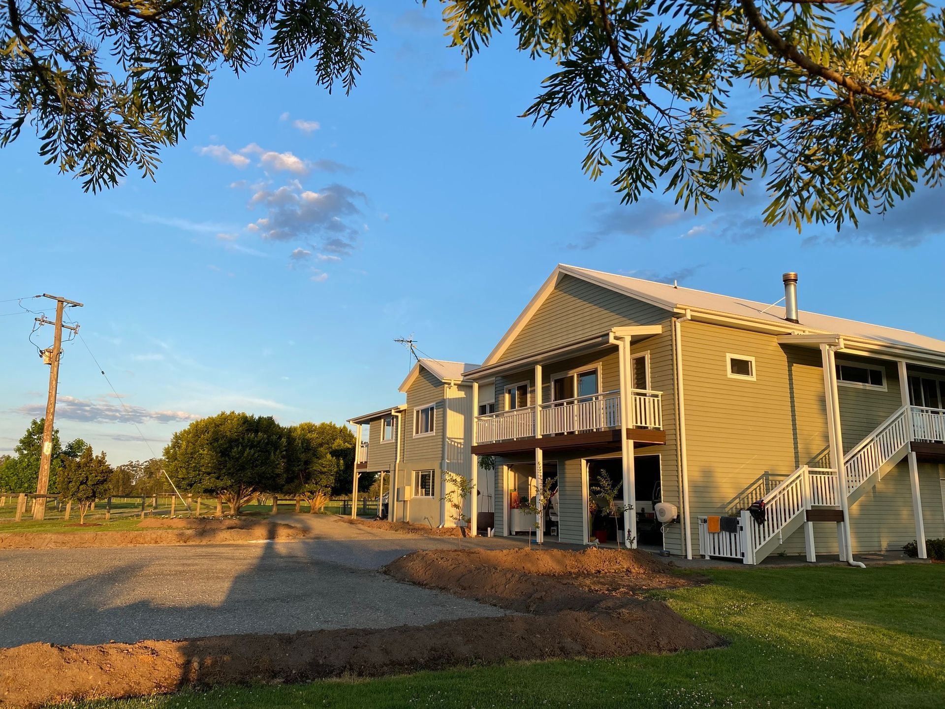 Exterior View of a Light Green House With a Porch and Stairs — BK Building Services Pty Ltd In Taree, NSW