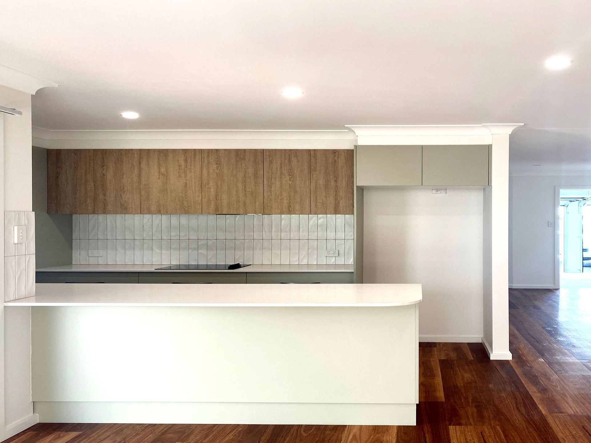 Kitchen With Wooden Cabinets, White Countertops, and Wood Flooring — BK Building Services Pty Ltd In Taree, NSW