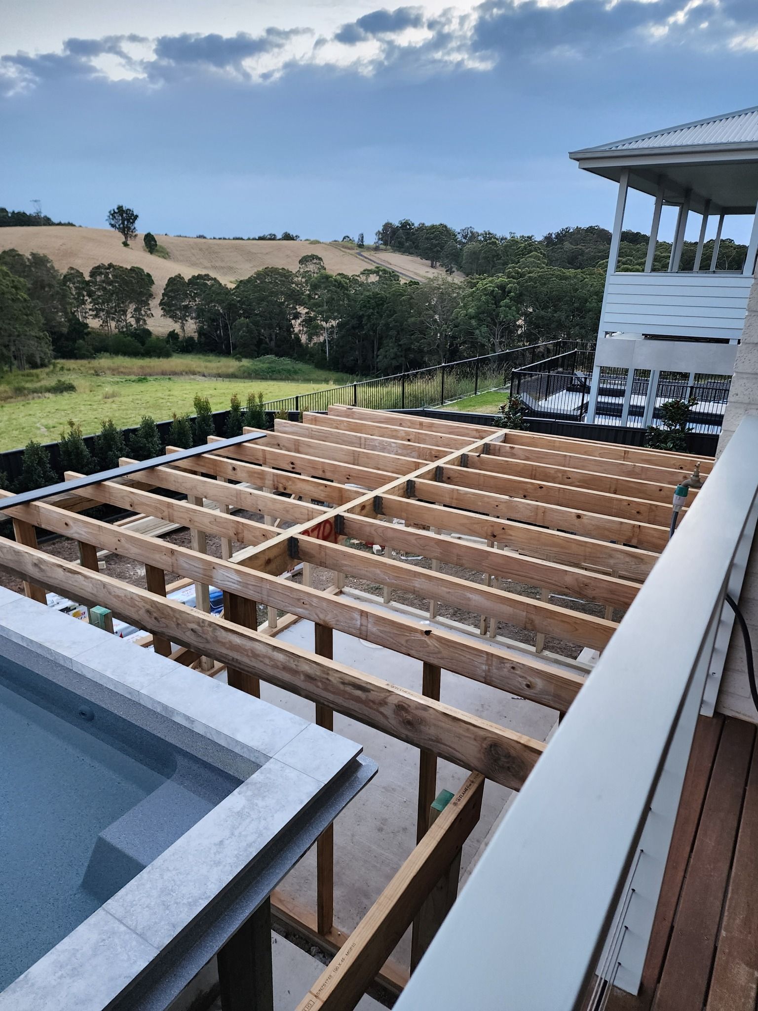Deck Construction With Exposed Wooden Beams Next to a Pool — BK Building Services Pty Ltd In Taree, NSW