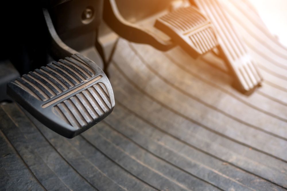 Car Pedals: Accelerator on the Right, Brake on the Left, Set on a Textured Floor Mat — Ottos Mufflers in Noosaville, QLD